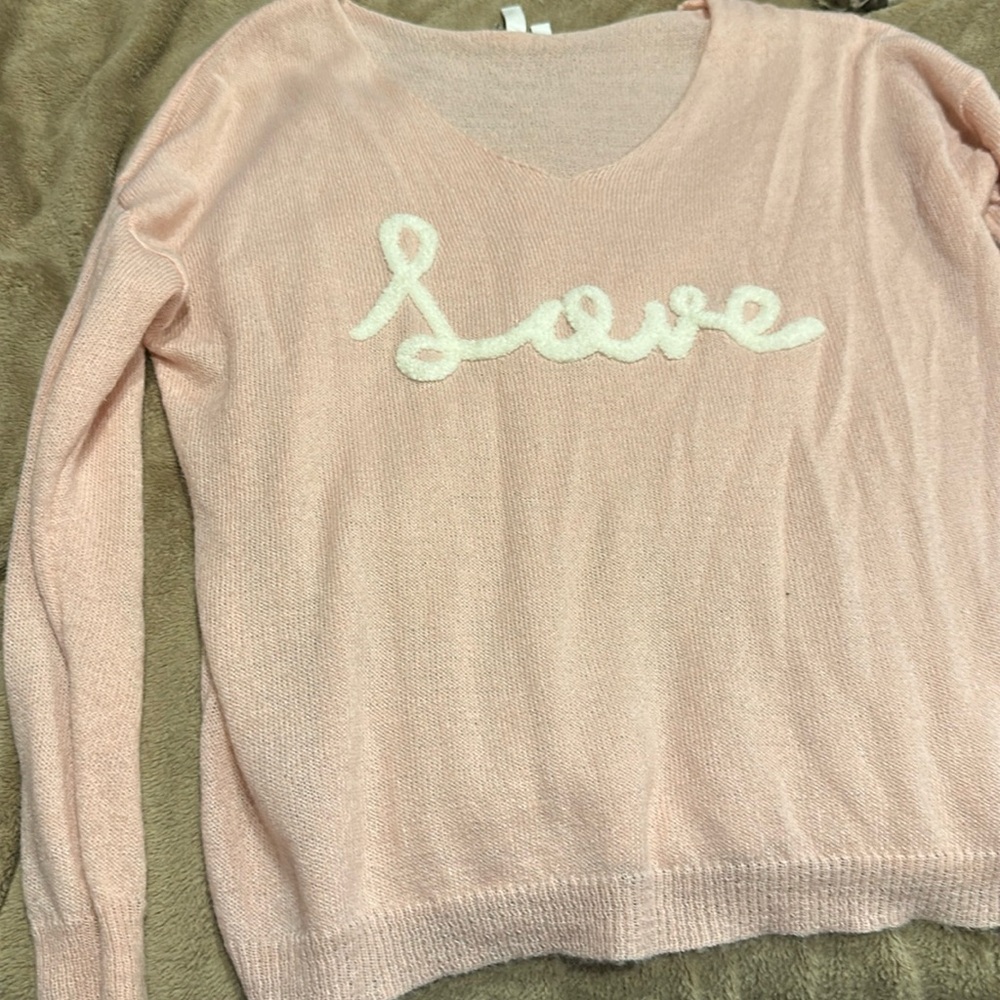 Over-sized knit sweater with Love stitched on. Size small but over sized
